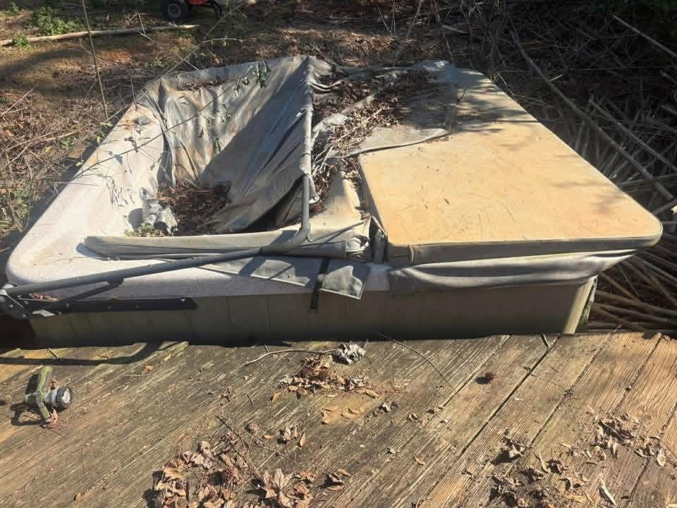 Old hot tub before removal from a deck